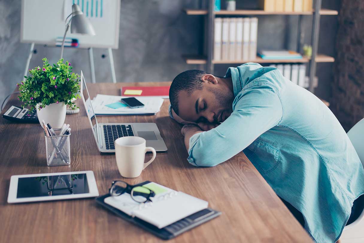 Man asleep at a work desk