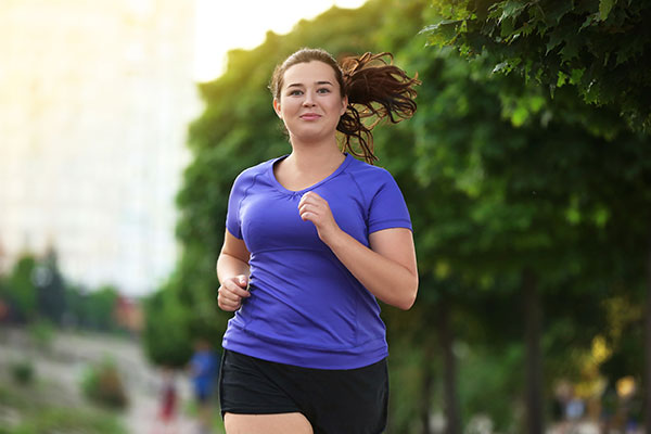 Young woman running outside