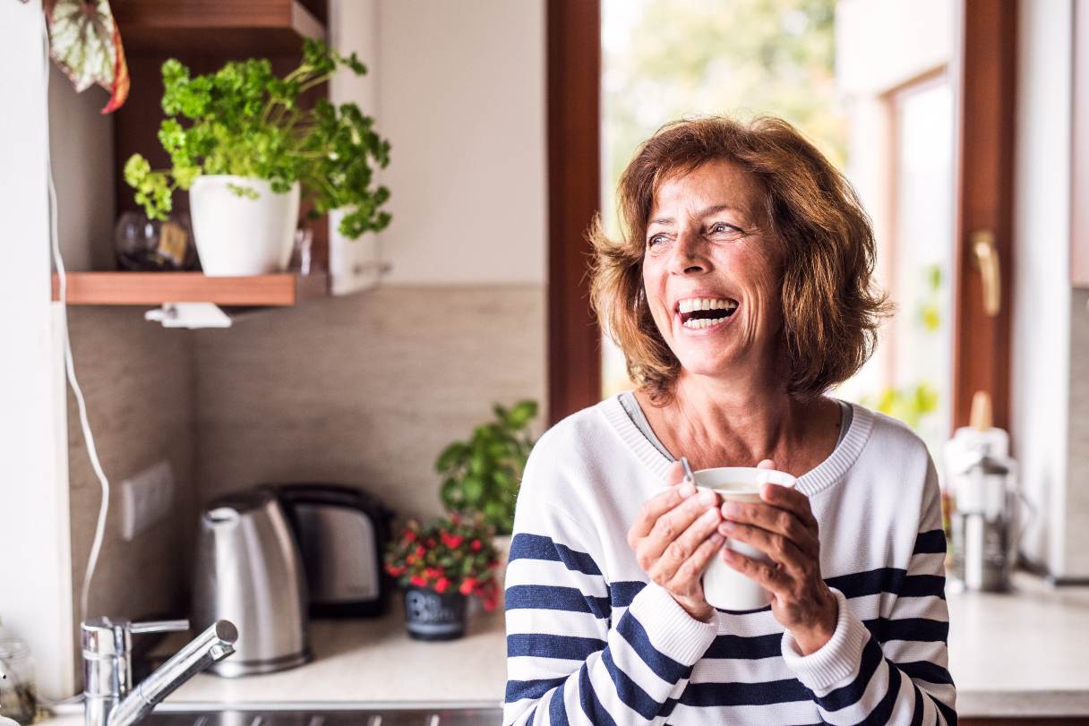 Smiling woman holding coffee mug