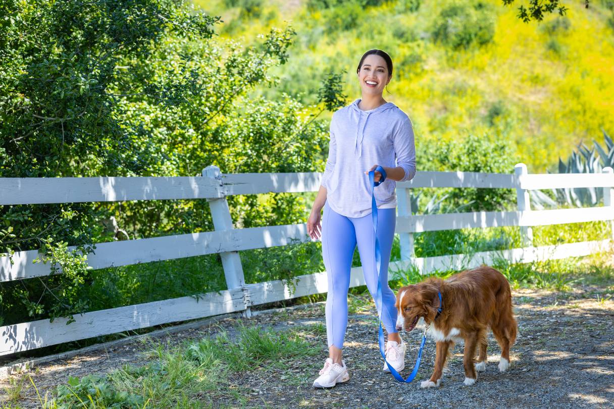 Woman walking outside with dog