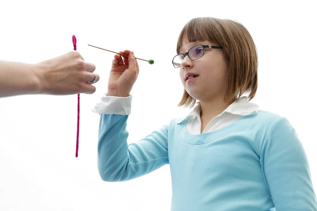 Young girl performing vision training