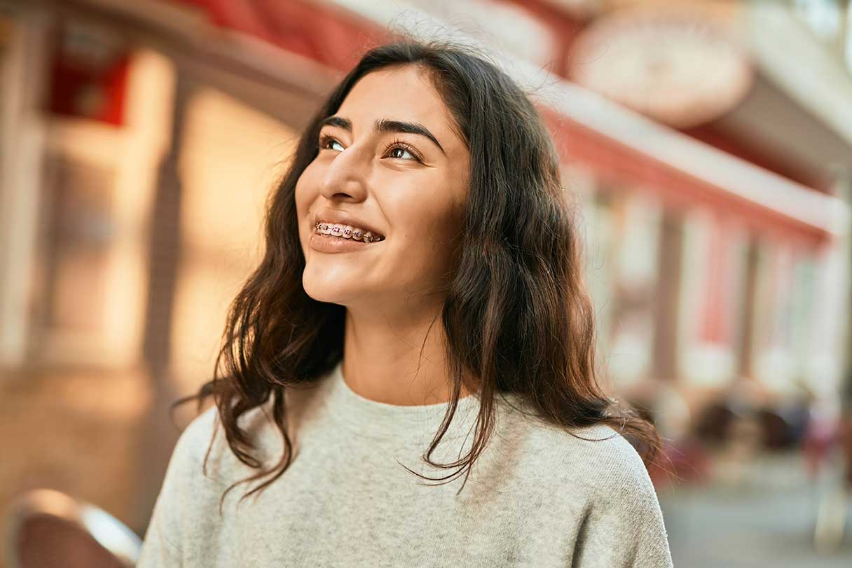 Girl with braces, smiling