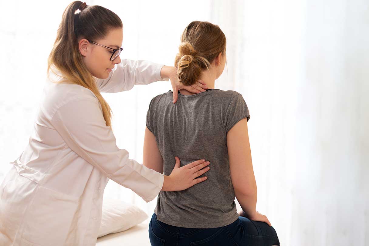 Chiropractor adjusting a patient's back