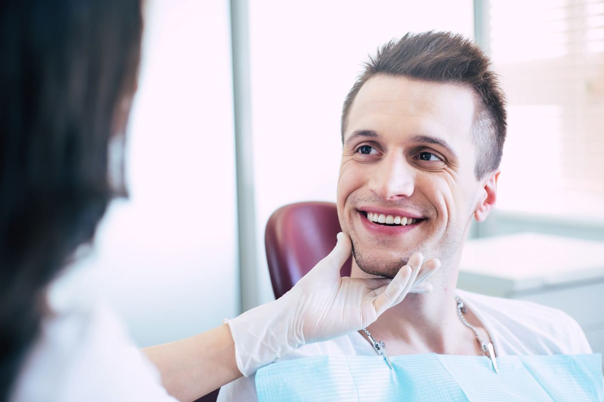Dentist looking at man's smile