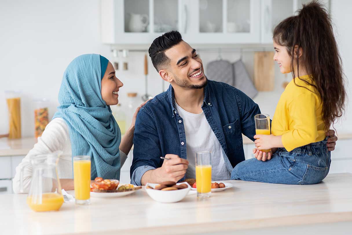 Couple smiling at their daughter