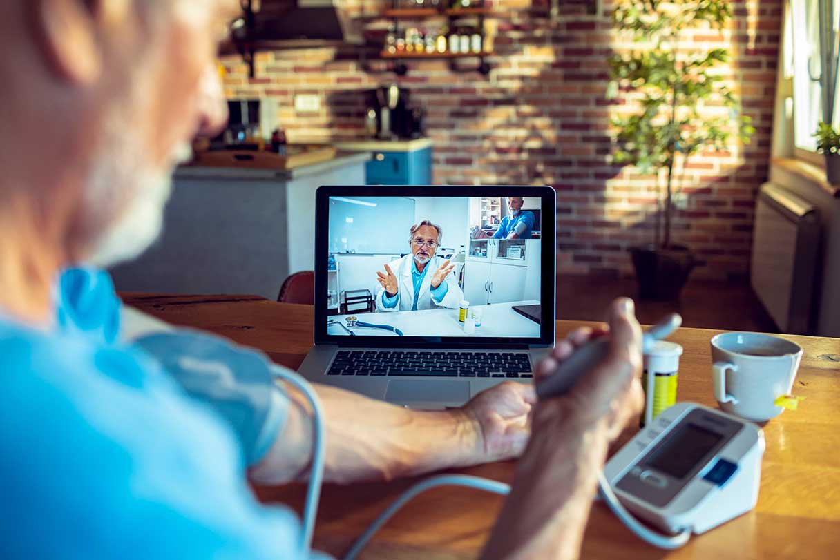 Man checking his blood pressure on a telehealth appointment