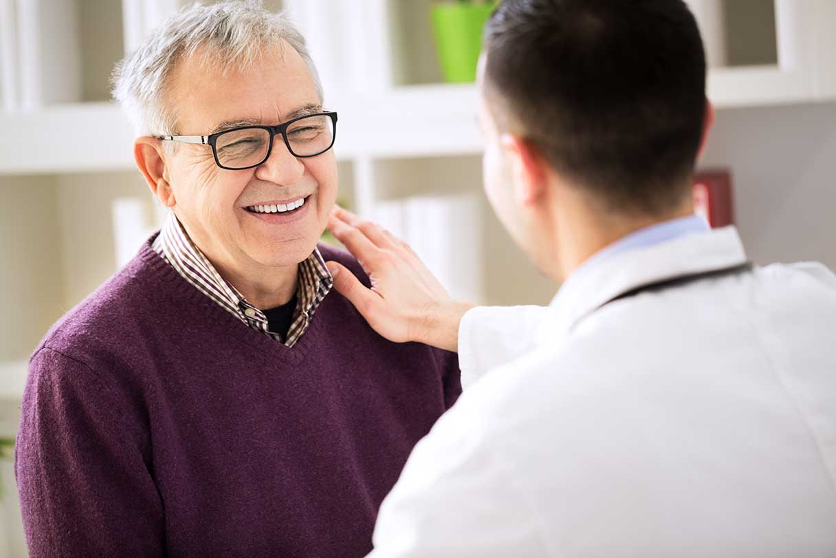 Doctor speaking to senior man