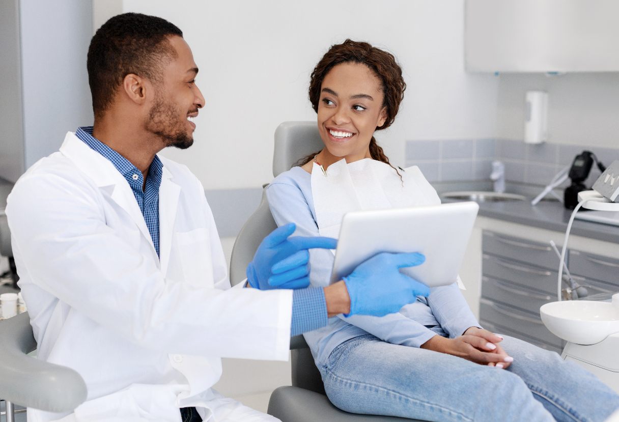 Dentist showing a patient a tablet screen
