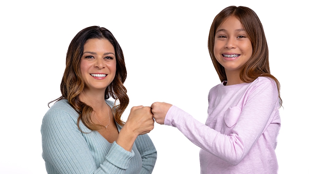 Mother and daughter bumping fists