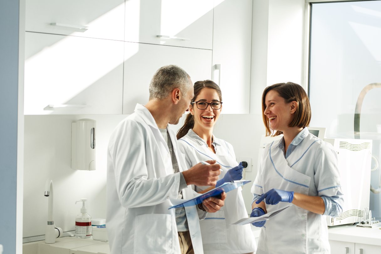Dentist speaking with dental hygienists 
