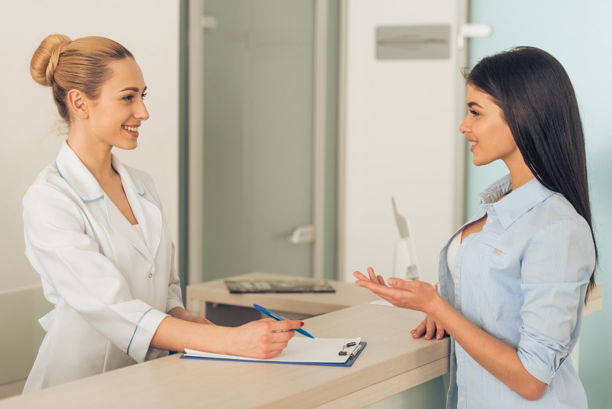Woman speaking with receptionist