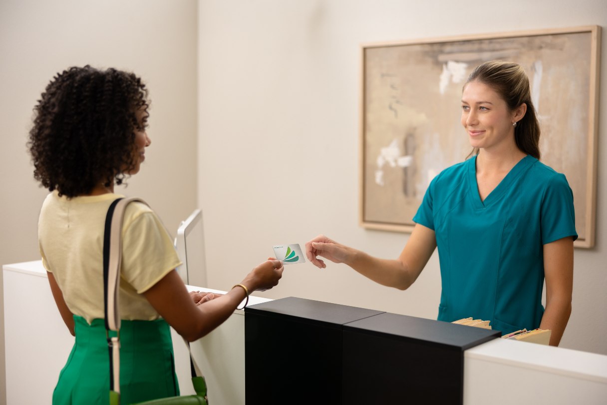 Woman paying with CareCredit credit card