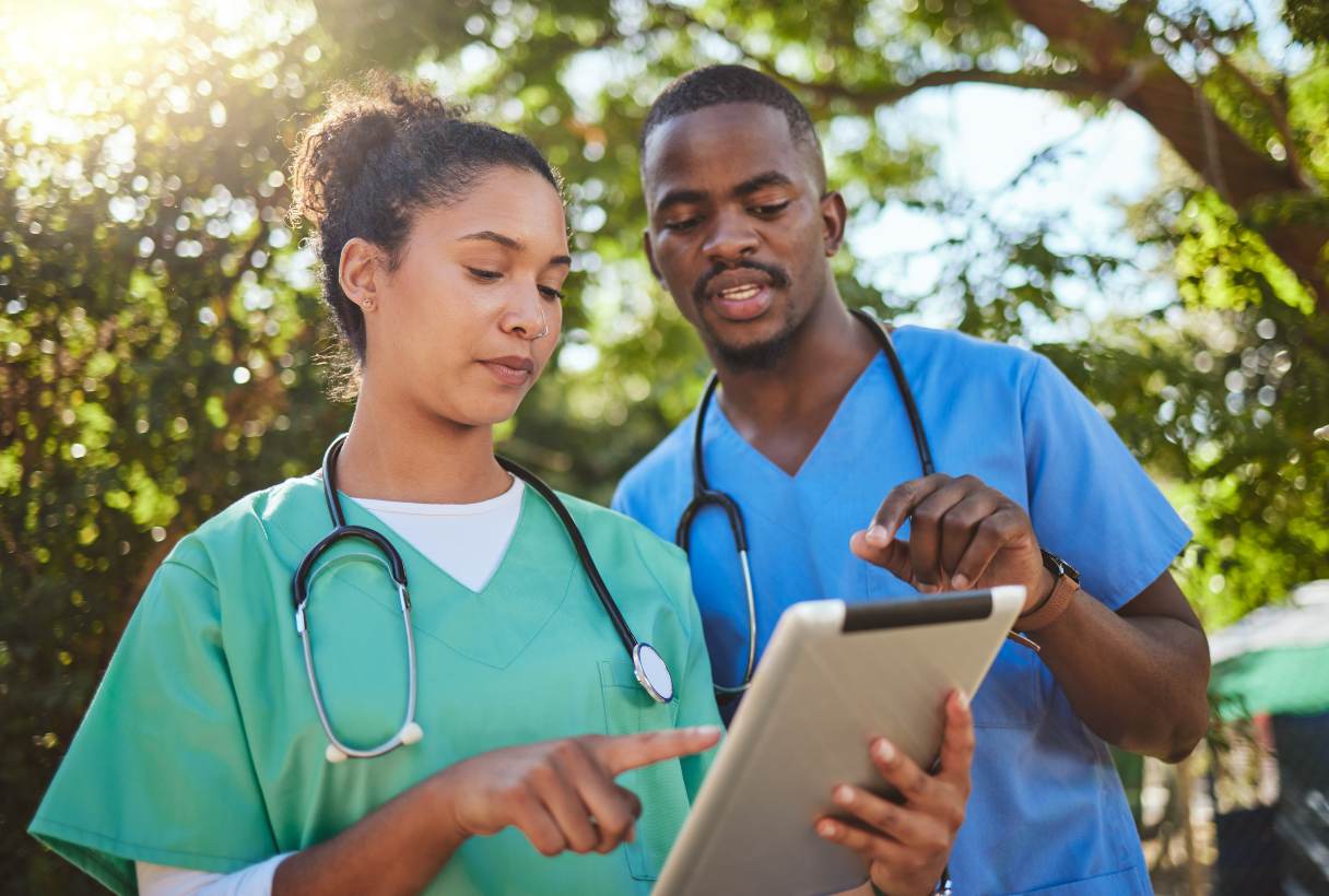 Two veterinary professionals looking at tablet device