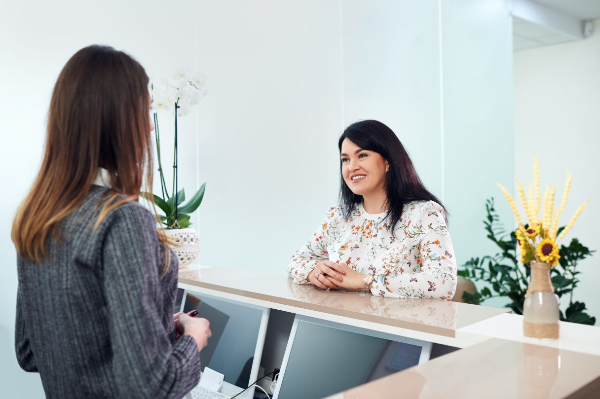 Woman speaking with receptionist